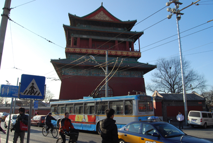 Cabs and electric buses work the streets of Beijing's old city centre in the shadow of Gu Lou (the Drum Tower)