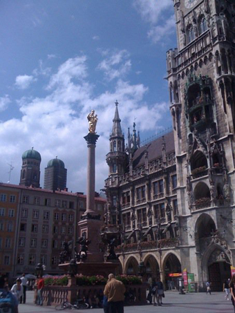 Munich's Rathaus (Old Town Hall) with the twin bell towers of the Frauenkirche in the distance