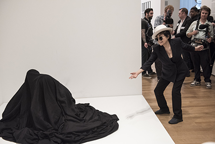  Yoko Ono interacting with people activating Bag Piece (1964), a participatory work in Yoko Ono: One Woman Show, 1960-1971, on view at MoMA, 17 May-7 Sep 2015